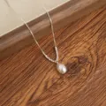 Elegant silver chain necklace with a delicate pearl pendant and metal beads. Daily wear accessory. - Silver Pearl Pendant Necklace