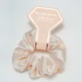 Macro view of champagne satin scrunchie with bridesmaid theme diamond card packaging - Champagne