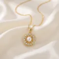 Close-up of a delicate gold pearl flower pendant necklace on white silk background. - Gold Pearl Flower (X0577)