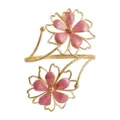 Elegant gold tone open arm cuff featuring dual pink enamel flower motifs for beach vacation style. - Pink