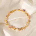 Elegant gold branch bracelet detailed with colorful cubic zirconia stones. Close-up jewelry shot. - Pink Purple White Rhinestone Gold (TS0469)