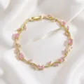 Close-up of gold-plated pink zircon branch bracelet, exquisite floral design, jewelry detail. - Pink Main Stone Floral Gold (TS0473)