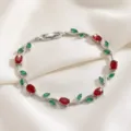 Detailed close-up of a stylish silver-tone branch bracelet featuring sparkling red and green zircon stones. - Red Green Main Stone Branch Silver (TS0482)