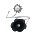Detail view of adjustable metal curtain tieback featuring black fabric flower and pearl accents. - Black & Silver