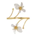Gold-tone open cuff arm bracelet with white flower charms, adjustable fashion jewelry accessory. - White