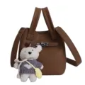 Brown lychee texture bucket bag with metal lock closure and cute plush bear pendant cross body. - Brown
