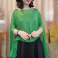 Detail view of a women's green sheer pullover shawl, lightweight summer cape outer wear. - Fruit Green