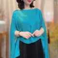 Turquoise cape detail view, lightweight sheer fabric, elegant split sleeve design, stylish look. - Lake Blue