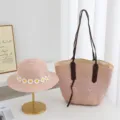 Detailed view of the pink straw sun hat with daisy flowers and matching straw tote bag. - Hat + Bag (2pcs Set) / Pink