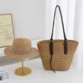 Detailed view of the woven straw tote bag and elegant sun hat on white table setup. - Hat + Bag (2pcs Set) / Khaki