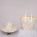 Detail view of woven straw tote bag and matching sun hat set, casual beach vacation style. - Single Hat / Off White