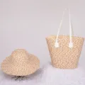 Detailed view of the stylish straw tote bag and matching beach hat with contrast color weave. - Khaki