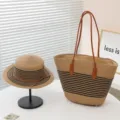 Detail view of the retro striped straw tote bag and flat-top sun hat set on white table. - Small Flat Top Patchwork with Upgraded Leather Base - Black
