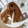 Solid brown cashmere feel knit scarf with elegant fringe detail for women winter warmth. - Caramel