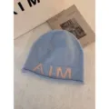 Blue wool knit beanie hat with pink letters, soft warm winter fashion headwear stylish cap. - One Size / Light Blue