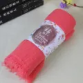 Coral pink cotton linen scarf with frayed edges, rolled neatly with paper band label for daily use. - Watermelon red