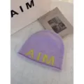 Stylish women's wool knit beanie in soft lavender with yellow letter design for warm winter. - One Size / Purple