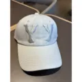 Washed vintage style baseball cap with stylish embroidered letters for casual outdoor daily wear. - Off White