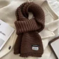 Cozy winter knit scarf detail, thick ribbed brown winter warm fashion scarf texture. - Coffee