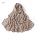 Close-up detail of soft modal cotton solid color scarf, elegant drape, breathable fabric. - Beige