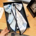 Elegant long silk ribbon scarf featuring light blue floral print and dark blue border for women. - Blue Flower