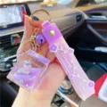 Leuke vloeibare eenhoorn fles sleutelhanger met paarse strap, ideaal voor auto en tas decoratie. - Paarse melkpak eenhoorn