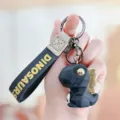 Leuke gefaseerde dinosaurus sleutelhanger met lederen band voor handtas en autosleutels. - Zwart