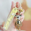 Vergulde beren sleutelhanger met gele band, schattige cartoon rugzak accessoire en cadeau. - Gradiënt Violent Bear - zilver-geel