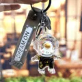 Schattige astronaut drijfzand sleutelhanger voor autosleutels, tassen en cadeaus. - Individuele Verpakking / Zwart & gouden astronaut - zittend geel gezicht