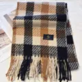 Close-up detail of classic plaid winter scarf, soft cashmere-feel fabric texture and fringe. - Creamy Black