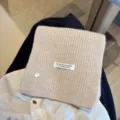 Cozy beige knit wool blend scarf with shell button and handmade label for winter warmth. - Beige