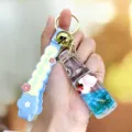 Leuke vloeibare soda fles sleutelhanger met schattig diertje en siliconen bandje. - Glinsterend champagne - Blauw