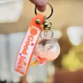 Schattige vloeibare drijvende lolly sleutelhanger met bel riem hanger voor auto sleutels en tassen. - Oranje