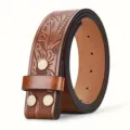 Detailed close-up of brown embossed leather belt strap with vintage carved floral pattern style. - 125cm / Brown
