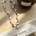 Detailed shot of a beach-style necklace with natural shells and a starfish pendant - Pink Seashell Beaded Necklace