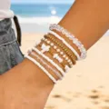 Bohemian multilayered handmade beaded bracelet set with white and gold beads on beach - Style 8