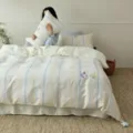 Detailed view of silky Tencel cooling bedding set, blue and yellow stripes with cute elephant embroidery. - 1.5m Four-Piece Set