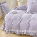 Purple milk velvet bedding detail showing exquisite embossed floral pattern and delicate white lace trim. - Four-piece Bedsheet Set For 1.5m Bed / Grey Purple