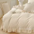 Detailed view of embossed milk velvet bedding with lace ruffles in a cozy warm bedroom. - Four-piece Bedsheet Set For 1.5m Bed / Off White