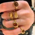 Vintage gold-toned irregular textured ring set with amber enamel stones worn on hand - Five-Piece Gold Chunky Bohemian Style (6617401HB)
