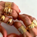 Set of chunky gold-toned rings with various textures and adjustable open bands for women. - Striped Rope Weave Irregular 7-Piece Set (6414001HB) / Gold