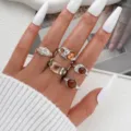 Set of 5 silver adjustable rings with irregular brown and amber stones on hand - Five-Piece Silver-Tone Vintage Irregular Style (6617402HB)