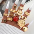 Vintage gold irregular ring set featuring a large red gemstone and textured patterns - Eleven-Piece Gold-Tone Red Stone Vintage Ring Style (6688101HB)