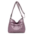 Sac bandoulière pour femme en cuir souple violet avec plusieurs poches et sangle réglable. - Violet
