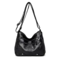 Black soft leather women's shoulder bag with multi-pocket zipper and adjustable crossbody strap. - Black