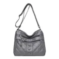 Grey soft leather shoulder bag with multiple zippered compartments and adjustable strap variant. - Gray