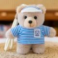 Cute cartoon plush bear keychain pendant with blue striped shirt and visor hat for bag decor. - Hoodie Style in Light Blue