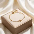 Detailed view of gold plated cross bracelet with rhinestones and delicate bead stations. - Rhinestone Cross Gold Bead Bracelet (FSY110SL)