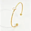 Gold stainless steel open cuff bracelet featuring sparkling marquise cubic zirconia details. - Gold Open Marquise Zirconia Bangle (RT235SZ)