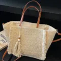 Casual straw woven tote bag for women with leather handles and chic tassel decoration. - Off White
